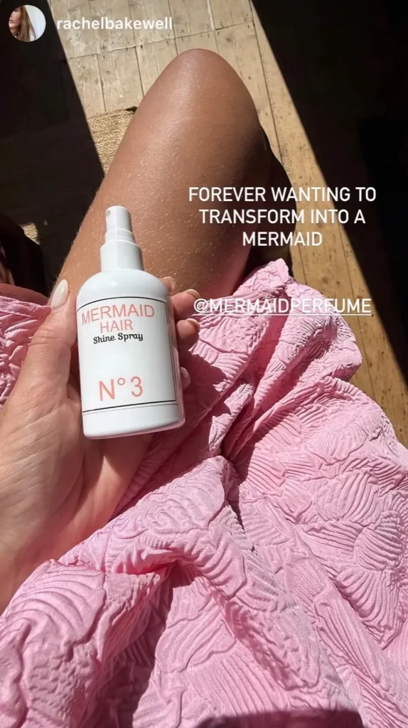 Fashion stylist Rachel Bakewell holding Mermaid No. 3 Hair Shine Spray outdoors for an editorial Instagram feature
